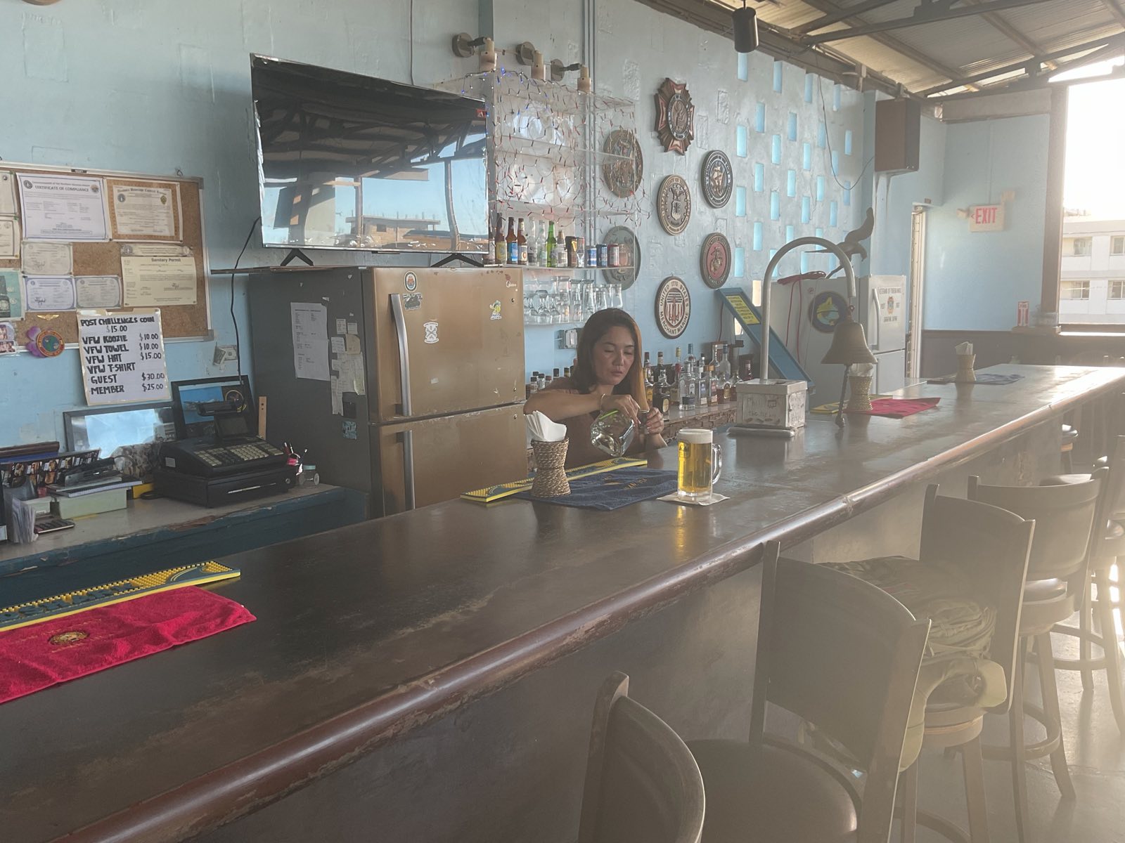 The canteen bar, framed by branch of service seals