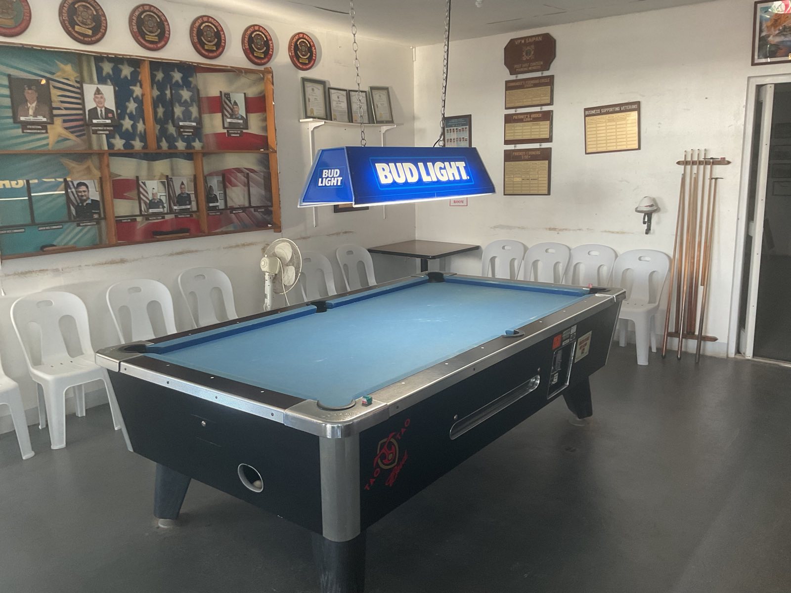 The pool table room, lined with Post officers and honors