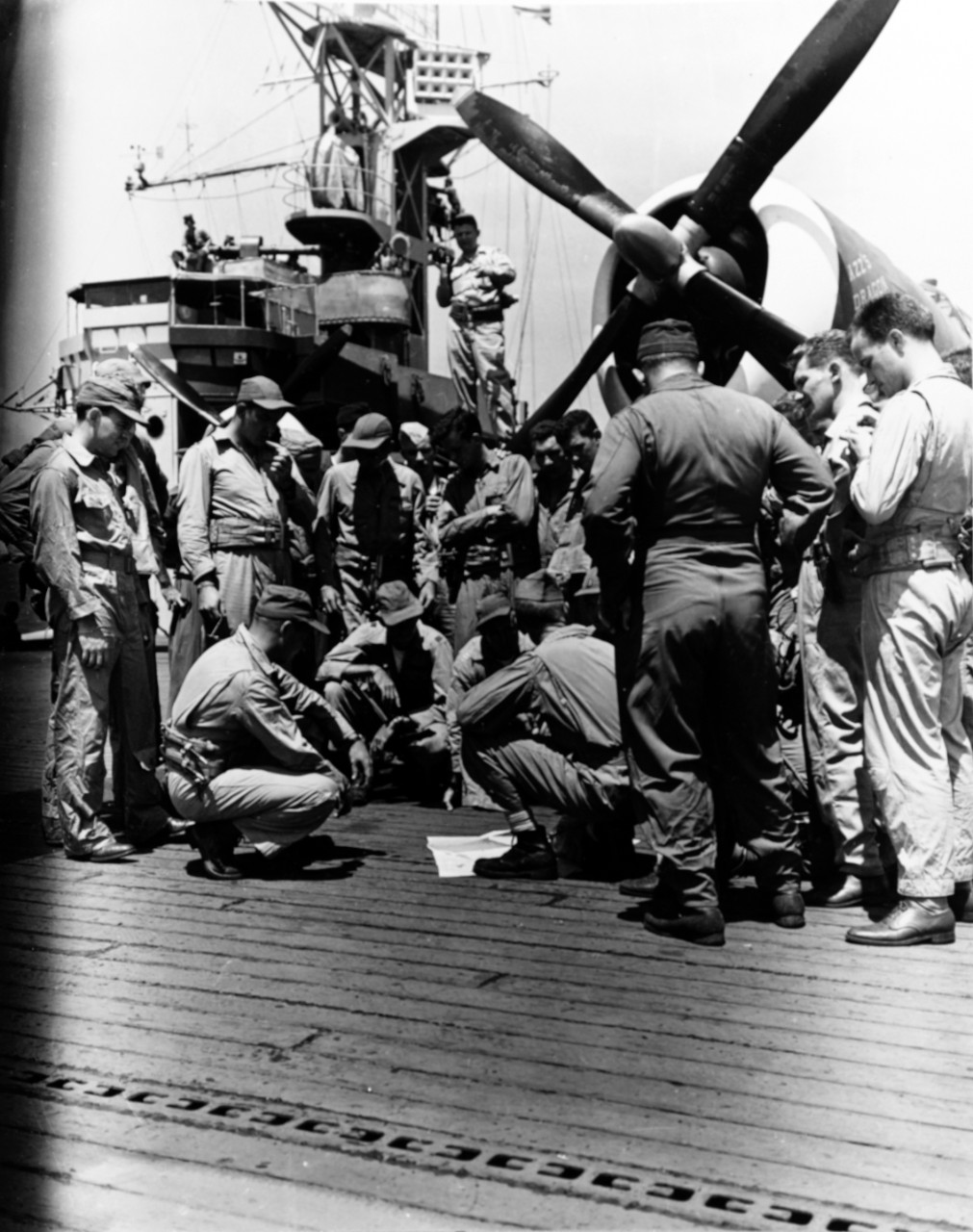 73rd Fighter Squadron pilots briefed aboard USS Manila Bay before departing for Saipan, June 24, 1944